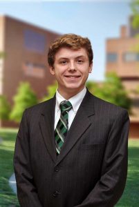 A three quarter portrait of Peter on the Library green.