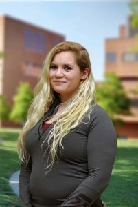 A three quarter portrait of Caroline on the Library green.